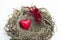 Heart and cupid figure placed into a wooden bird nest