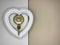 Heart on a doorknob with a key. The white heart opens with keys. Concept: closed heart