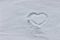 Heart drawing in the snow. Heart shape on fresh pristine snow. Winter background