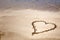 Heart drawn in sand with copy space