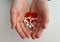 Heart electrocardiogram icon and white pills in children hands