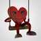 Heart figure swings on the seesaw