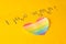 Heart in the form of a LGBT flag on a yellow background and the inscription I love women, the concept of lgbt, lesbian bisexual