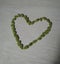 Heart formed by green seeds. green beans