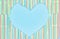 Heart frame of colored plastic straws or cocktail tubules on light blue background with copy spase