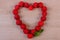 Heart of fresh raspberries on wooden table, symbol of love