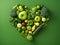 Heart of green fruits and vegetables isolated on deep green background. Green life concept and healthy eating lifestyle. Shape of