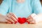 Heart in hands, female holds handmade sewn soft toy