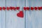 Heart hanging on rope on blue background