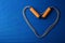 Heart from jumping rope on blue yoga mat background