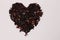 Heart from of karkade tea petals on white background for mix with hot water to drink