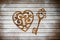 Heart and a key of the flour as a symbol of love on wooden background. Valentines day background. Vintage retro card.