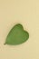 Heart leaves are placed on brown cardboard. Symbol ESG, CSR social responsibility, biofuel renewable energy concept, world
