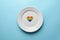 Heart in LGBT flag colors in plate. Romantic gay dating in cafe or restaurant. Waiting for special LGBT guest for wedding banquet