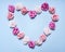 Heart, lined with paper roses on a blue background top view close up decorations for Valentine\'s Day top view close up