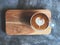 Heart love piccolo latte art in white cup on wooden tray and cement floor with natural light