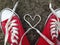 Heart Love shape symbol with sneakers teen baseball urban `teen love` or healthy heart exercise concept red boots with laces heart