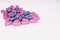 Heart made of blue and pink pills. Heart made of different colored tablets isolated on white. Copyspace for text. Epidemic, painki