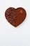 Heart made of coffee beans and powder isolated on white.