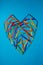 a heart made of colorful wooden sticks creatively arranged