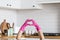 Heart made of pink protective gloves on white kitchen background.. Woman hands wearing protective gloves. Concept of