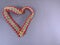 Heart made of ribbon with lace, isolated background. Heart shape made of decorative ribbon with patterns. Element for holiday card
