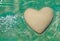 Heart made of sand floating in transparent ocean ripples water b