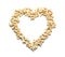 Heart made of tasty cashew nuts on white background