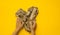 Heart made of wooden sticks on a yellow background.