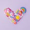 Heart from many kids accessories from clay, wax chalk on purple pastel background, Concept of pop art culture, abstract, 80s, 90s