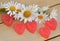 Heart of marmalade with a wreath of daisies on wooden boards