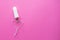 Heart of Medical female tampon on a pink background. Hygienic white tampon for women. Cotton swab. Only one tampon on a pink