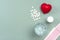 Heart, medical pills, cardiogram, glass of water, capsules on gray background.