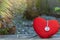 Heart with medical stethoscope on wood backdrop on tree blurred background.for health care emergency take care of warning of