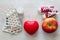 Heart medications, canvas shoes, apple and red heart, natural and medical remedies for healthy heart concept