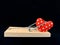 Heart in a mousetrap on a black background. A trap with a heart, Love is like a bait. Valentine`s Day, Love Day