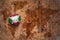 Heart with national flag of burundi on a vintage world map crack paper background.