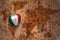 Heart with national flag of mexico on a vintage world map crack paper background.