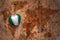 Heart with national flag of nigeria on a vintage world map crack paper background.