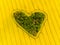 Heart of a nature, aerial view of heart shaped forest among yellow colza field