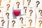 Heart with note paper with question mark inside love concept