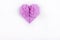 Heart of origami of purple paper on a white background.
