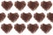 Heart pattern of heap roasted coffee beans isolated on white background.
