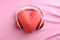 Heart pillow and headphones on pink background love songs/podcast