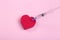 Heart on a pink background with a medical syringe. Heart health and love and medicine concept