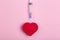 Heart on a pink background with a medical syringe. Heart health and love and medicine concept