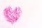 Heart of pink mallow petals on a light background with space for text. Card