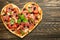 Heart pizza love concept Valentines day romantic dinner Italian pastries. on a wooden table. Flat-lay