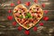 Heart pizza love concept Valentines day romantic dinner Italian pastry with red hearts. on a wooden table. Flat-lay