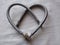 Heart of the plumber is made of water hoses for a sink, a metal braid of steel color, St. Valentine`s Day, St. Valentine, the top